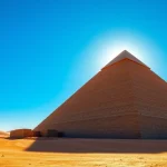 Captivating view of the piraminds with textured stones against a blue sky.
