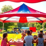 Families enjoying a picnic under a colorful canopy tent at an outdoor event.